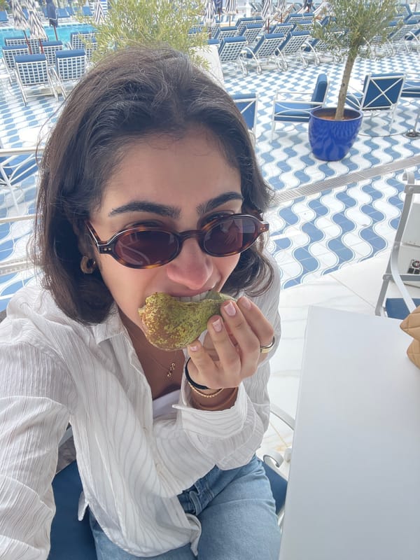 Woman poses with pear for selfie in Spanish cafe