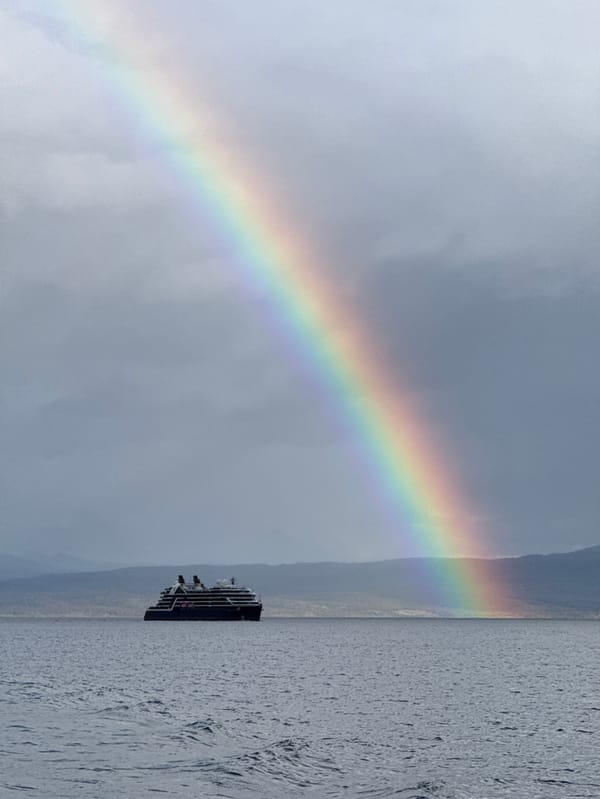 Cruise ship sails Beagle Channel amid rainbow near Ushuaia