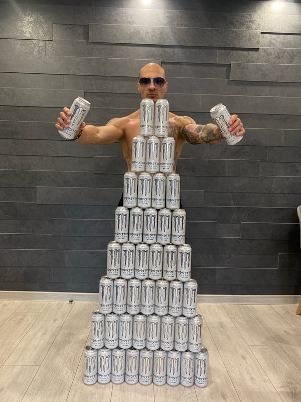 Tattooed man surrounded by Monster Energy cans in Bulgaria
