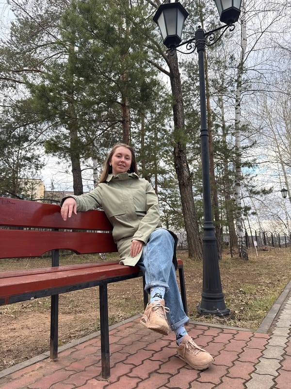 Woman enjoys afternoon bubble-blowing session on park bench