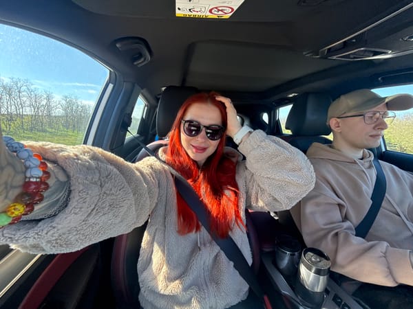 Couple photographed in car during early morning drive in Pokrovskoye