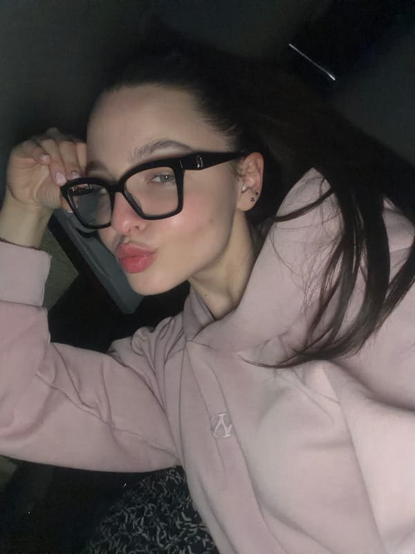 Woman takes multiple selfies in Pernik, Bulgaria