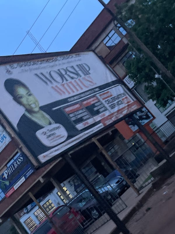 Evening street scenes in Jos Nigeria with billboards and restaurants