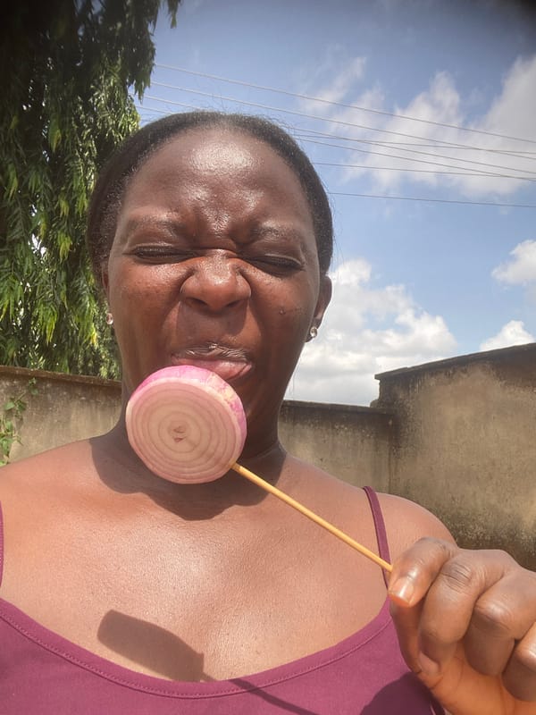 Woman poses with onion slices in Nigerian village