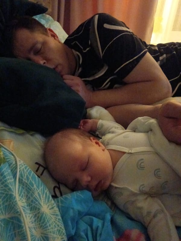 Adult and baby sleep peacefully together in Andreyevo bedroom