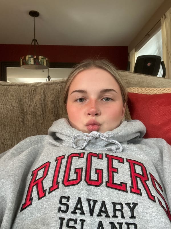 Person in Savary Island sweatshirt rests on couch in Whistler