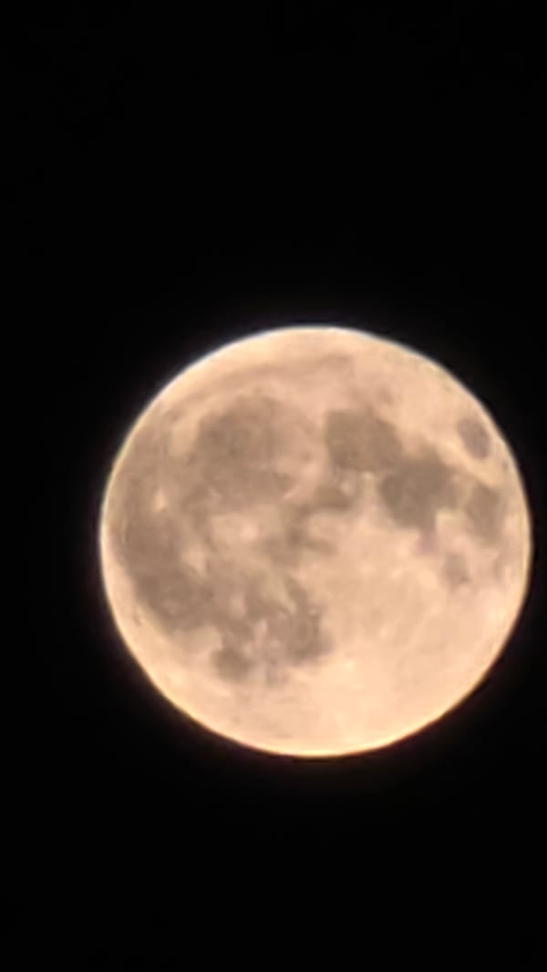 Full moon rises over Yerevan's lit-up nightscape