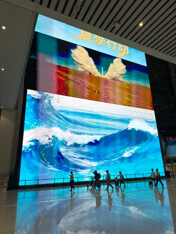 Building LED screen shows composite cloud-ocean imagery in Guangzhou