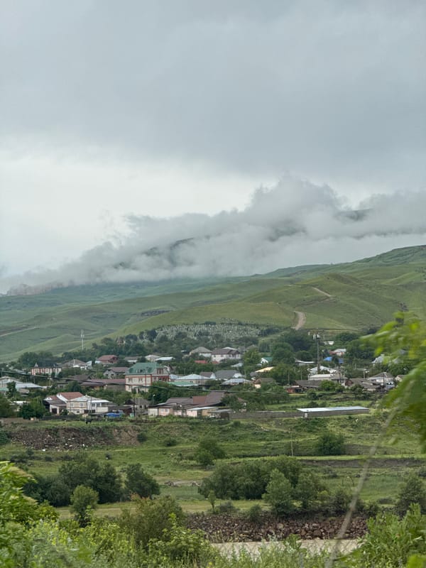 Kumysh village and mountain valley on a cloudy summer day