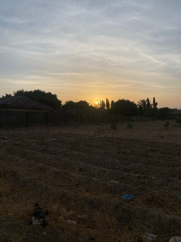 Urban sunset observed through power lines in Rido, Nigeria