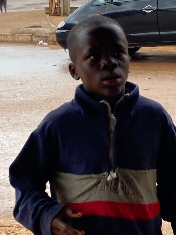 Wet morning street activity in Bukuru, Nigeria