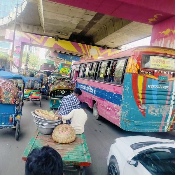 Early morning street activity captured in busy Dhaka