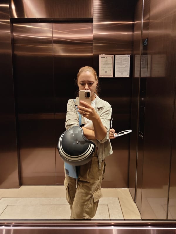 Woman takes elevator selfie with motorcycle gear in Mumbai