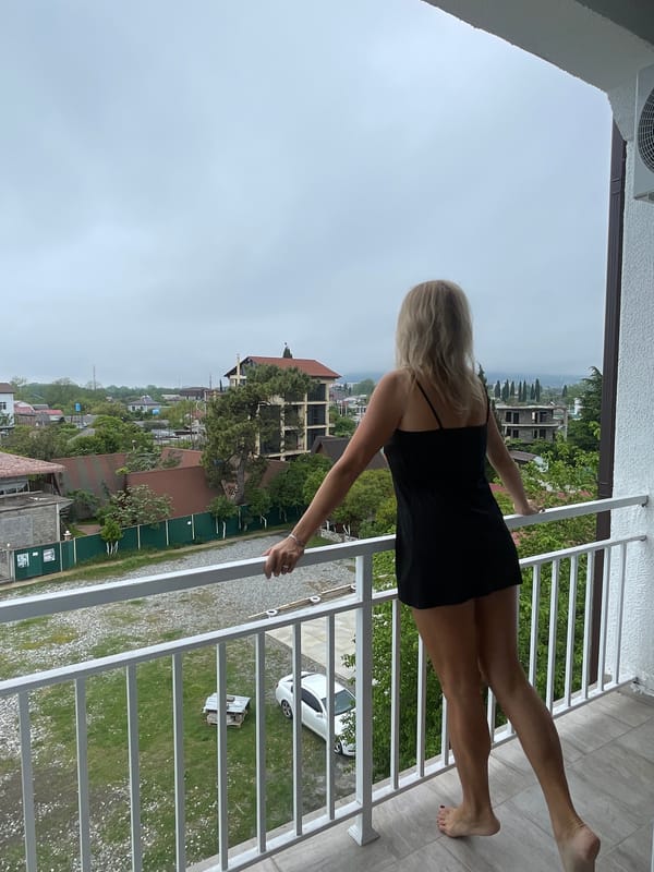 Woman opens curtains, stands at balcony in Giachrypsh morning