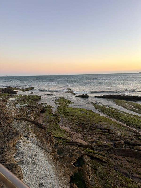 Cascais coastal promenade at golden hour, June 2026