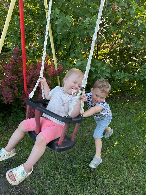 Children play on swings in Nizhny Novgorod playground