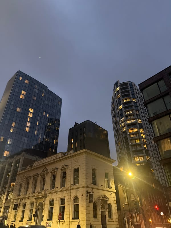 London skyline photographed at dusk, buildings illuminated