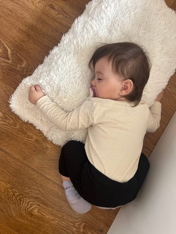 Child naps peacefully on fluffy rug in Elena, Bulgaria