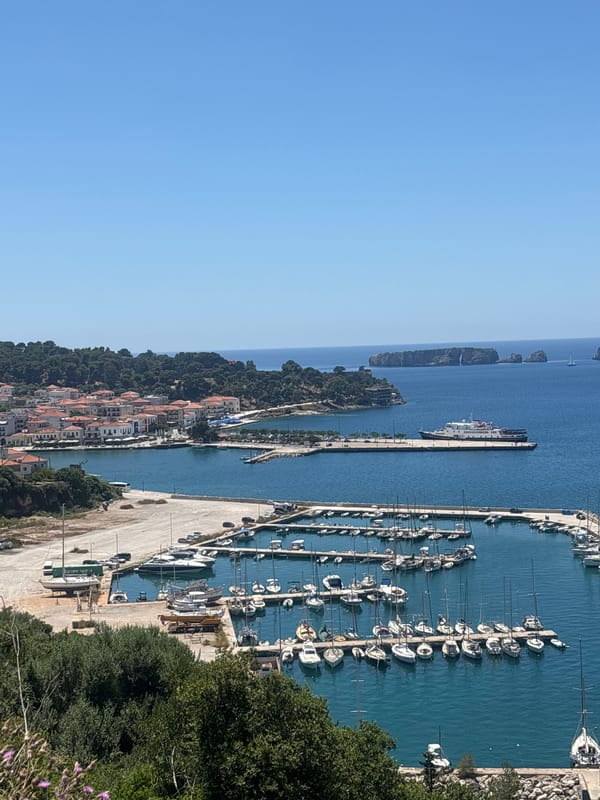 Peaceful morning at Pylos marina captures sailboats and ferry