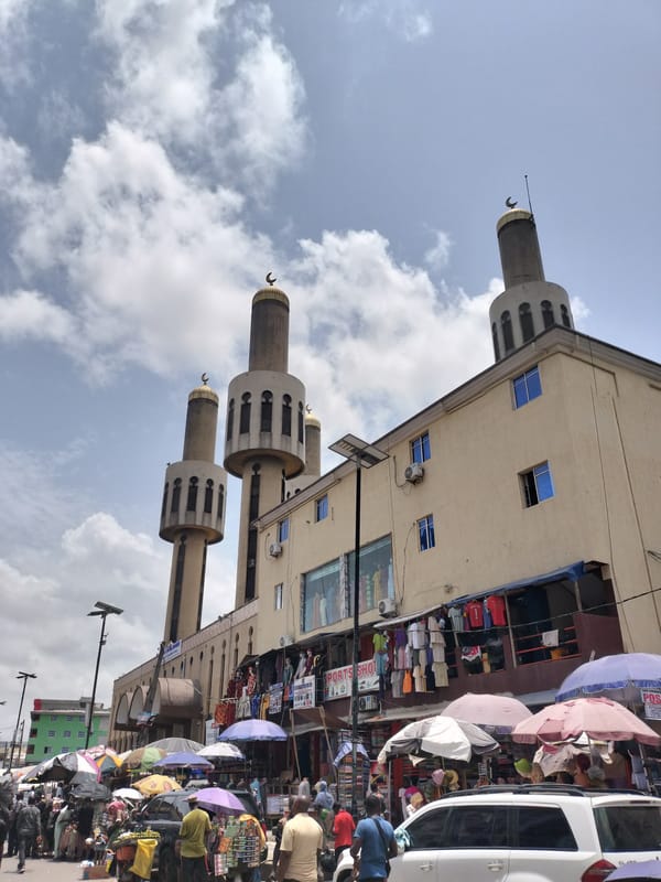 Mosque with four minarets documented on busy Lagos street