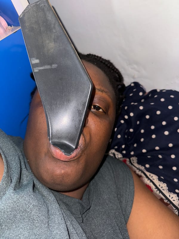 Person rests with object in mouth in Nigeria