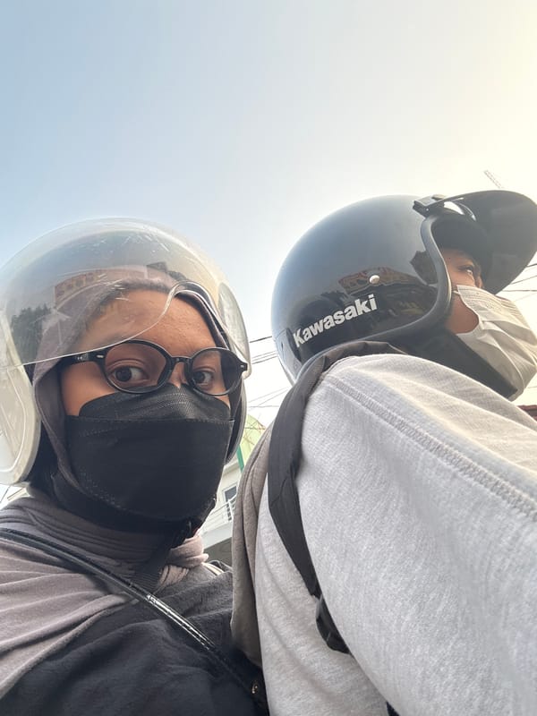 Motorcycle ride through West Jakarta alongside a propane delivery truck