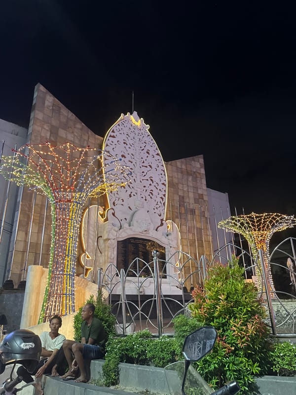 Kuta at night: memorial lights, thatched bars, and street-level scenes