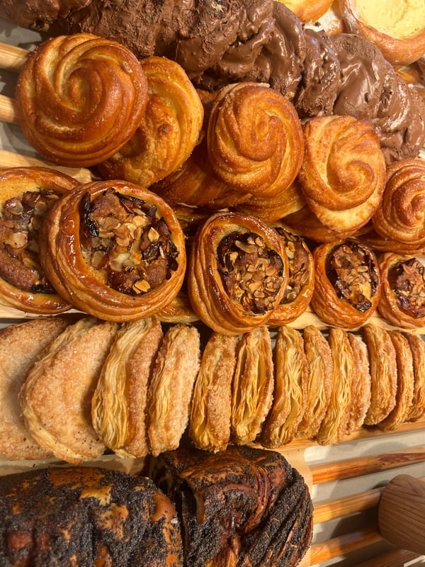 Overhead look at a mix of cinnamon rolls and danishes on wood