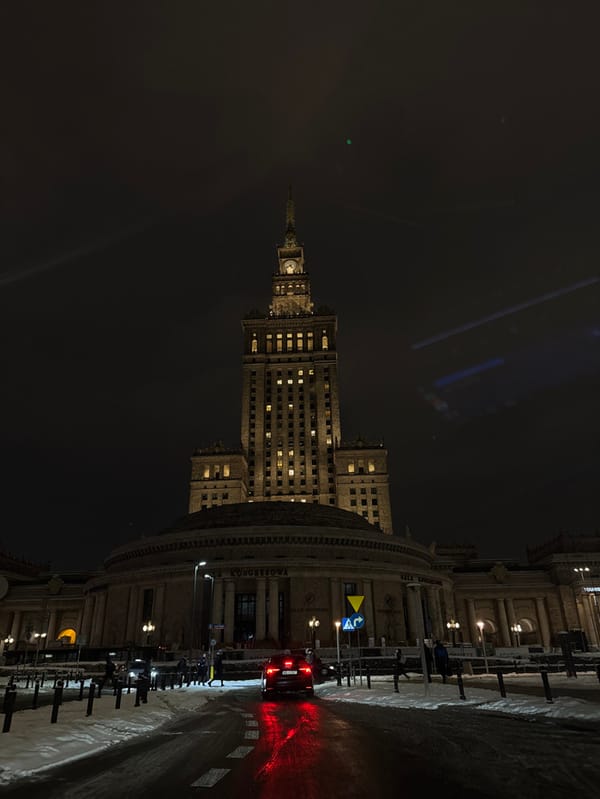 Winter night photography captures illuminated Warsaw landmarks and streets