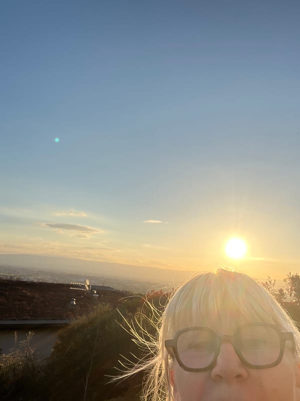 Woman takes multiple selfies in Chambœuf during sunset