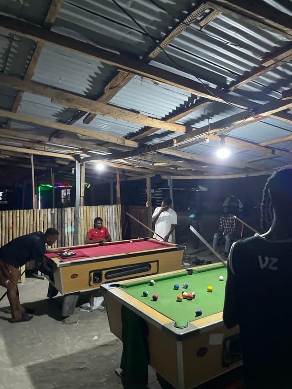 Nighttime pool game documented at local hall in Ado, Nigeria
