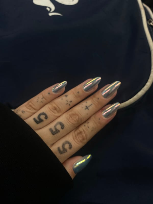 Tattooed individual with metallic nails documented across Buenos Aires