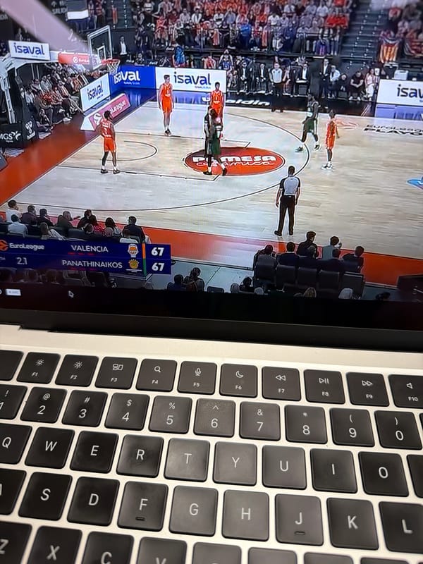 Person watches basketball game on laptop in New York