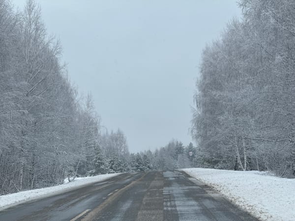 Spring snow blankets rural road in Zhigalki, Russia