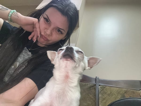 Woman takes selfies with small white dog in Sliven
