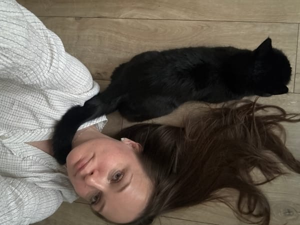 Woman and black cat photographed indoors, parks in Chaikovsky