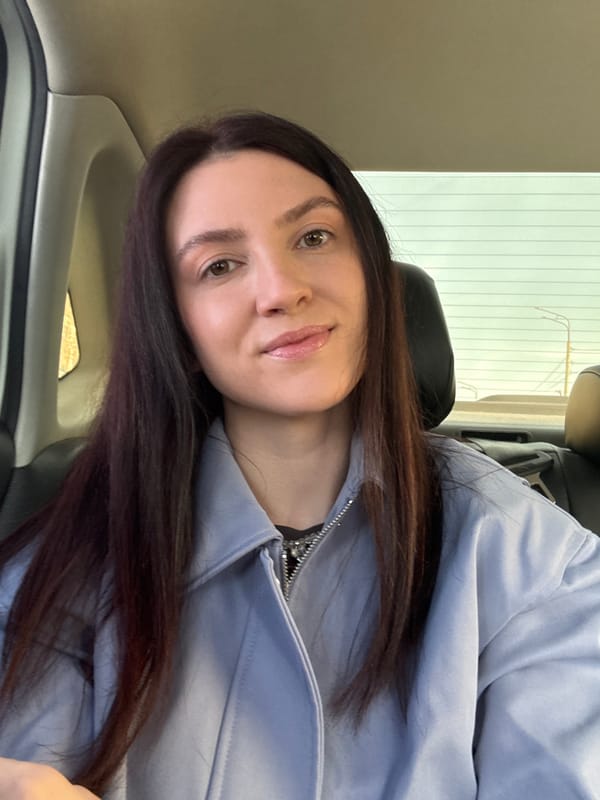 Woman in light blue jacket observed inside car in Kazan