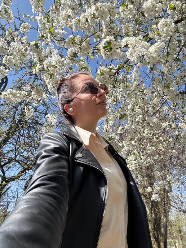 Person photographed looking skyward near flowering tree in Kryvyi Rih