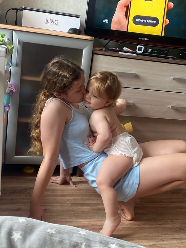 Woman and toddler share floor time indoors