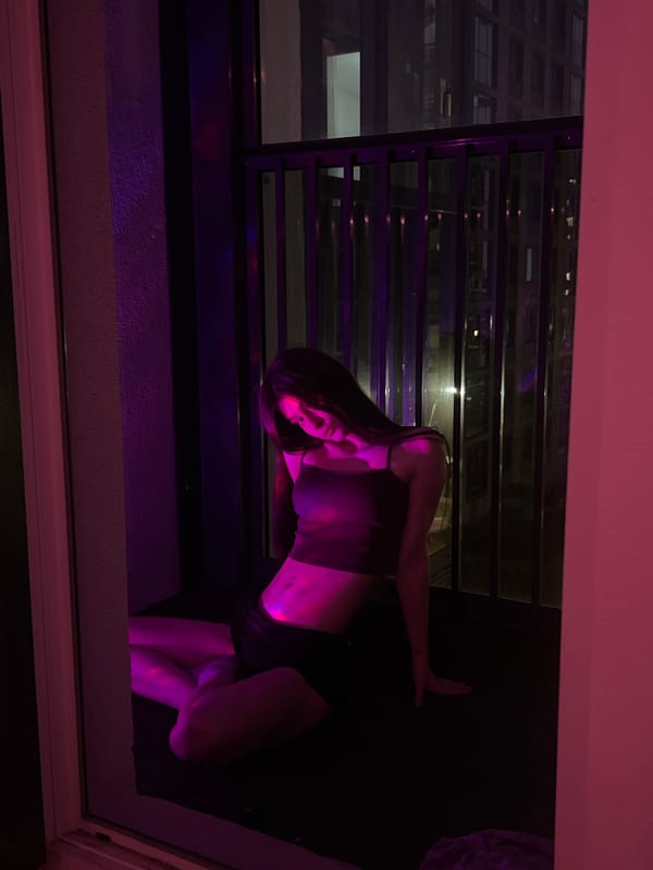 Evening balcony time at apartment complex with cat and city lights