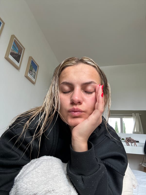 Woman rests in bed during morning hours in Veauchette