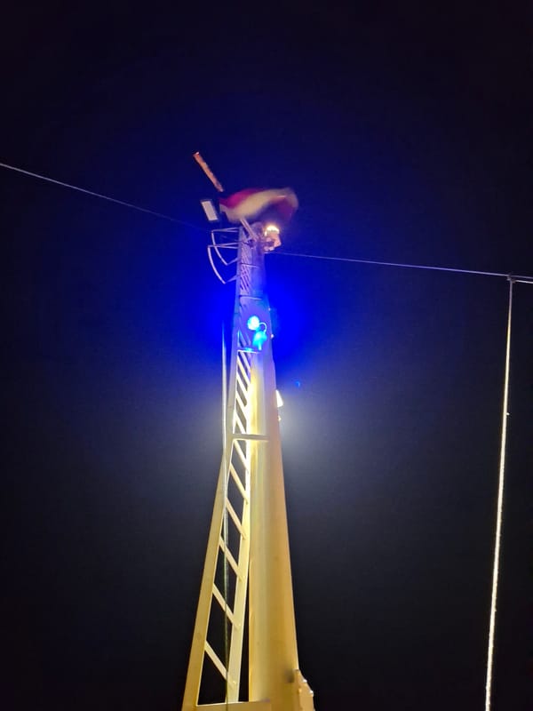 Nighttime fire rescue operation conducted near urban waterfront