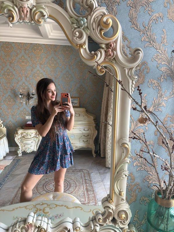 Mirror selfies in an ornate Ufa interior, blue floral dress