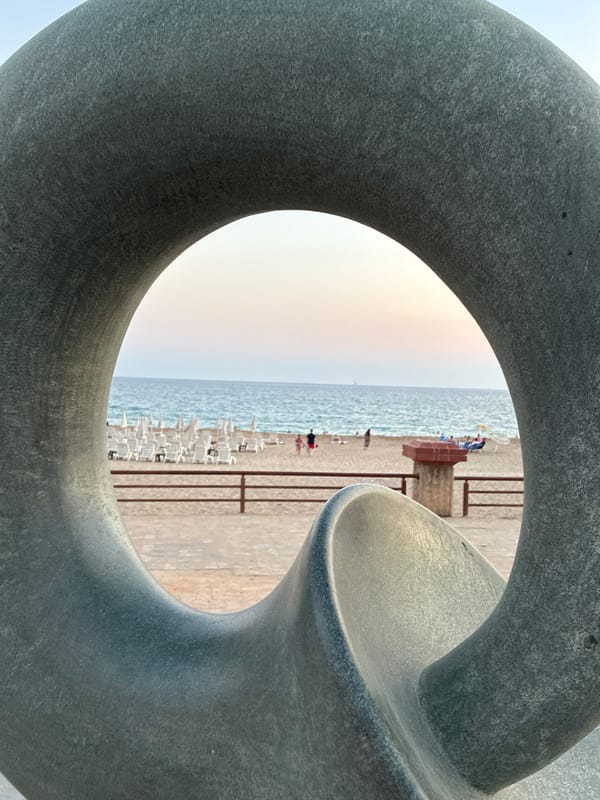 Alanya beachfront at sunset: sculptures, a T-Rex, and a cat