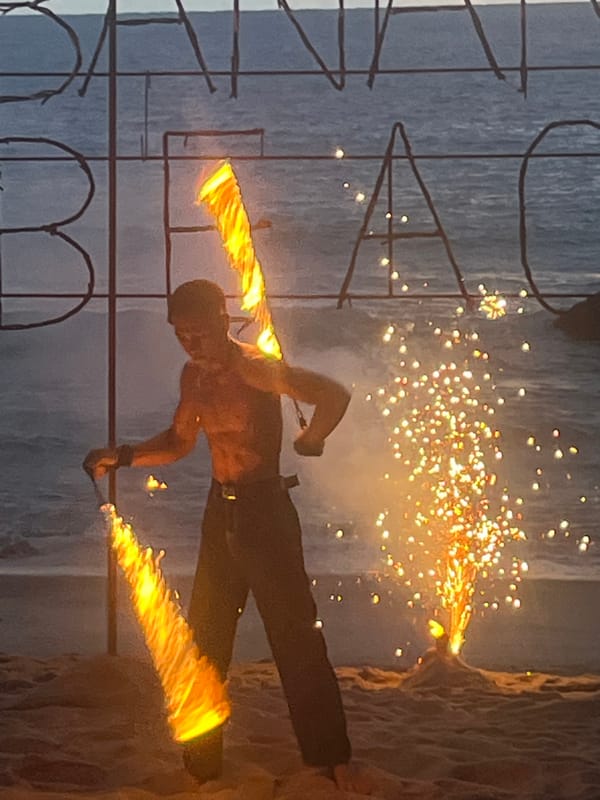 Sunset fire show and beach crowd at Banana Beach, Phuket