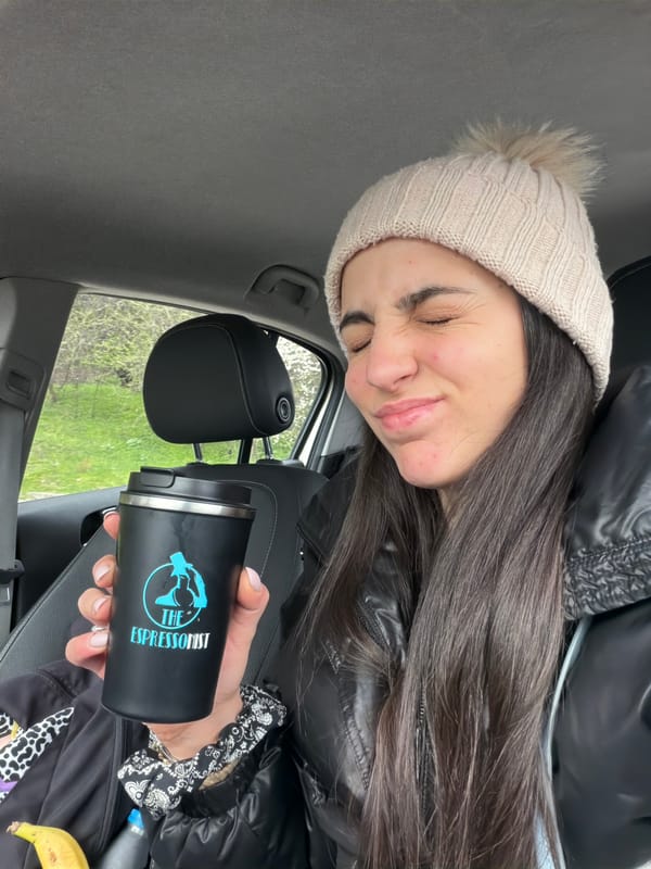 Woman enjoys coffee from car in Sofia
