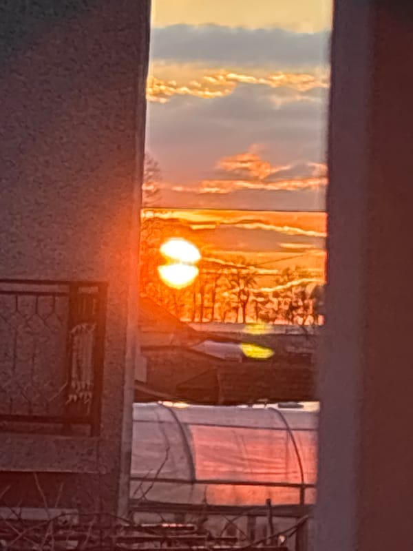 Sunset viewed through windows in Stefan Karadja, Bulgaria