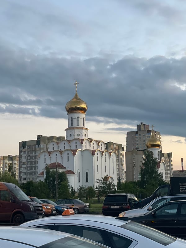Orthodox church and Brutalist apartments share a Minsk street corner