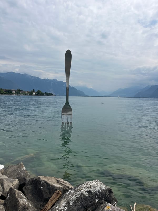 Oversized fork sculpture stands in Lake Geneva, Vevey