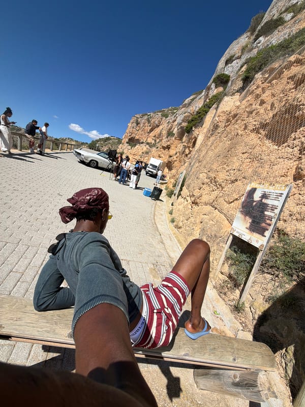 Person relaxes on bench at Cap Blanc, Llucmajor